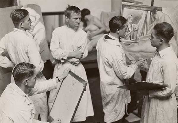 A photo of the painter Otto Dix instructing a class in figure painting, taken in 1929