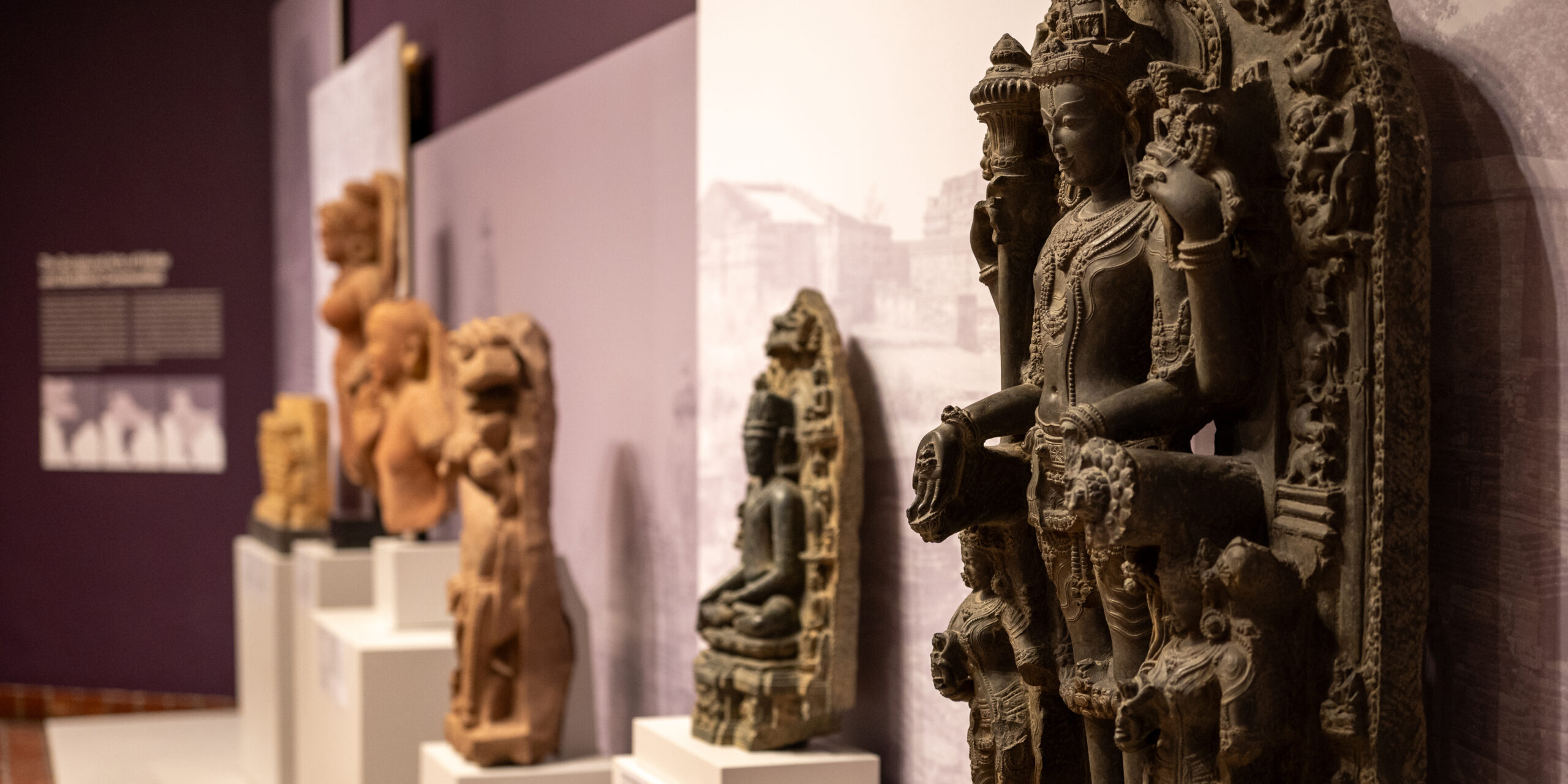 A perspective view of a row of various Asian statuettes