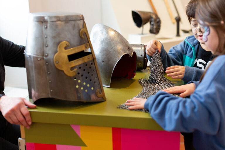 Children examining armor at an Art Cart