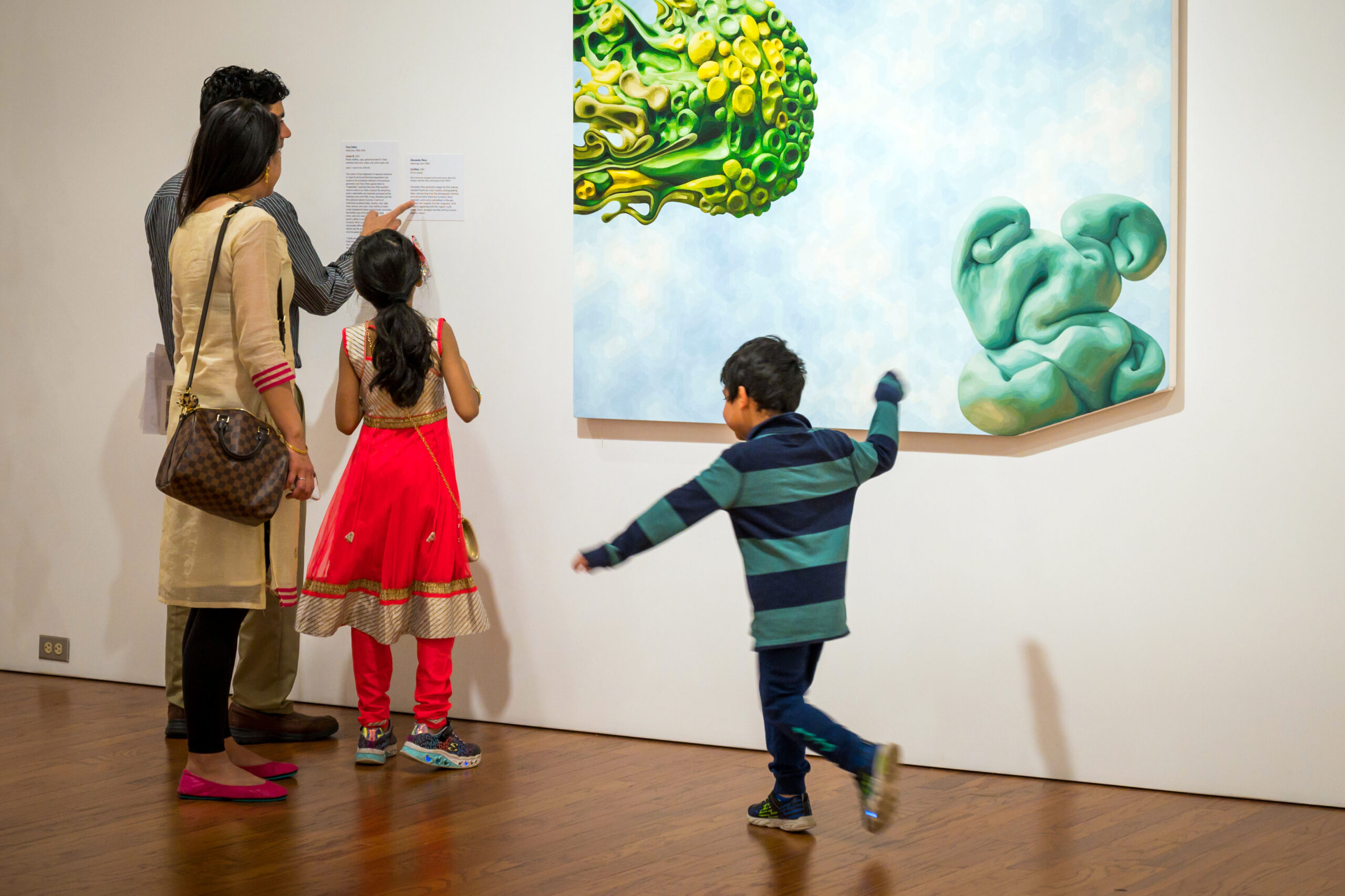 A family of four exploring a gallery together