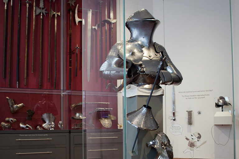 View of a Medieval Gallery: stechzeug armor in the foreground and open storage in the background