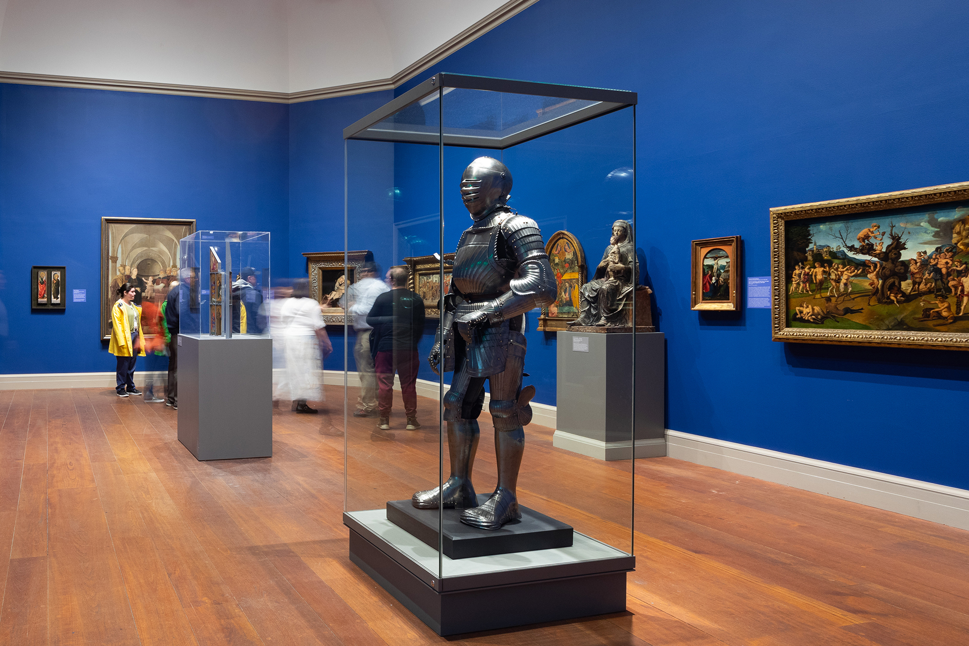 A suit of armor on display in a European art gallery