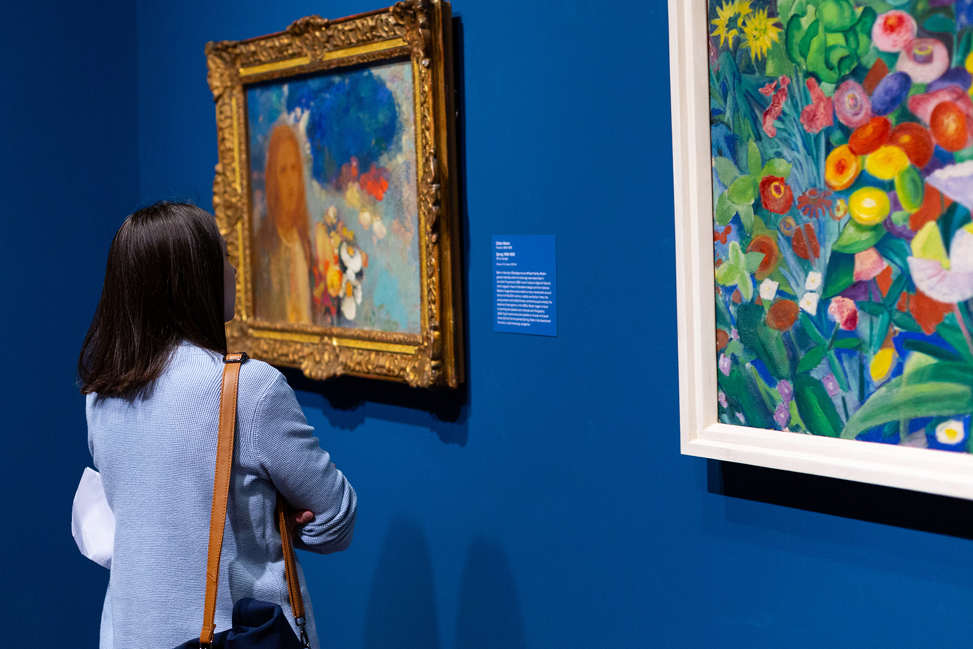 A visitor viewing works in a European gallery