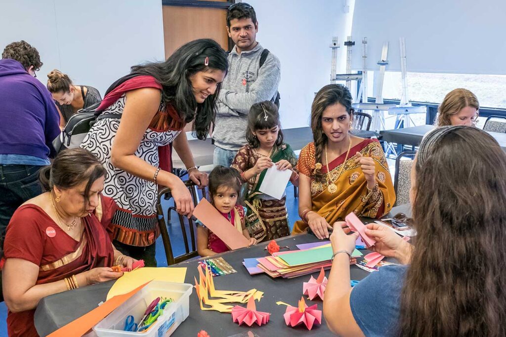 A group making paper flowers in a studio