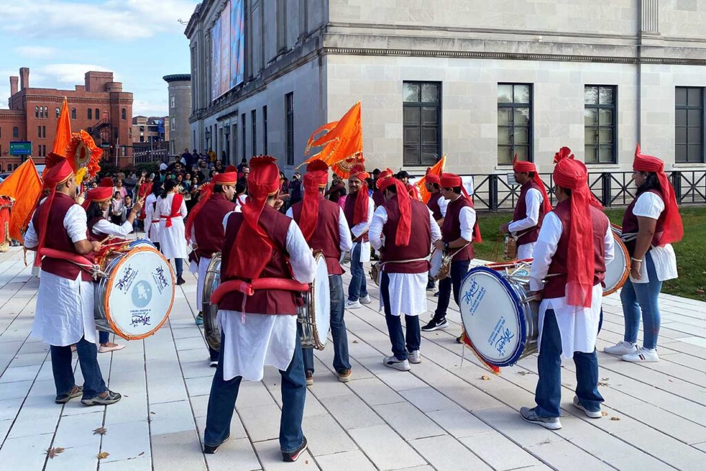 A Dhol Tasha group performing outside the Museum