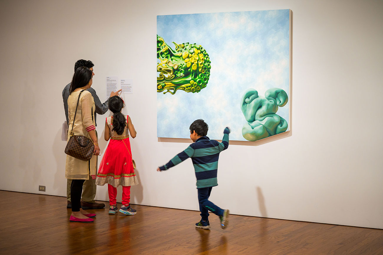 A young family viewing a work in the Post-45 gallery