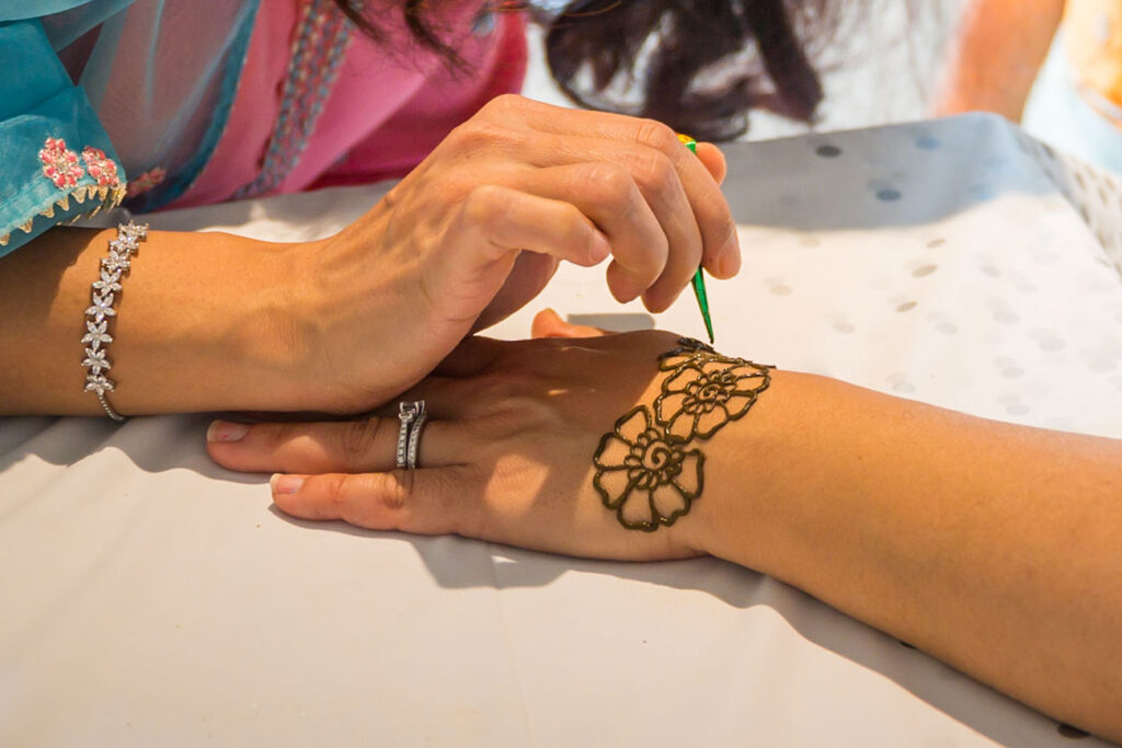 Close-up of a henna artist at work